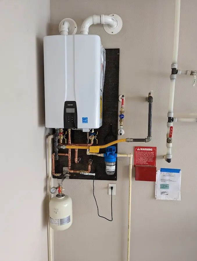 Professional plumber installing copper piping in a New Haven home